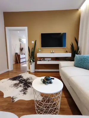 a living room with a white couch and a tv at The Modern Suite Life with Terrace in Sofia
