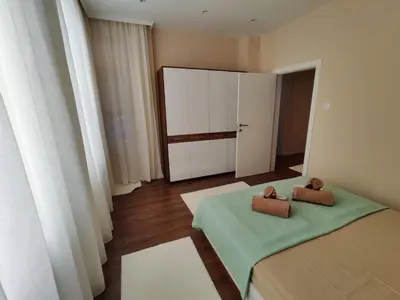 a room with two beds and a door with towels at The Modern Suite Life with Terrace in Sofia