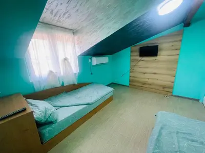 a small bedroom with a bed and a window at Вила Маца in Sapareva Banya
