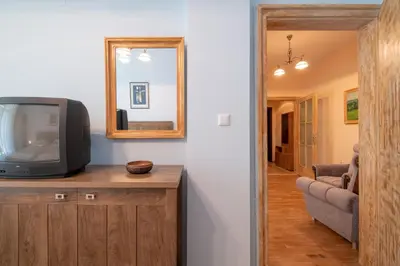 a television sitting on top of a wooden cabinet in a living room at Urban Haven Retreat in Sofia