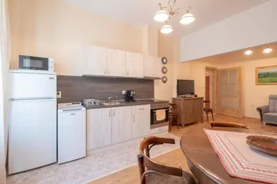 a kitchen with a white refrigerator and a table at Urban Haven Retreat in Sofia