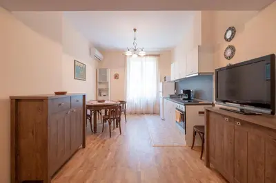 a kitchen and dining room with a large flat screen tv at Urban Haven Retreat in Sofia