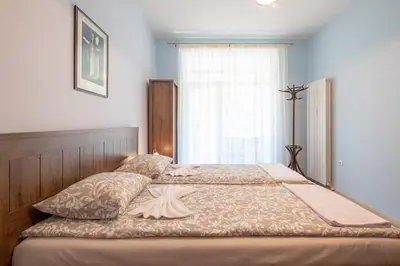 a bedroom with a large bed with a window at Urban Haven Retreat in Sofia