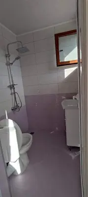 a bathroom with a toilet and a sink at Guest House Proynovi in Kalofer