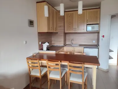 a kitchen with a wooden table and chairs at Belvedere Holiday Club К505 Sunset View in Bansko