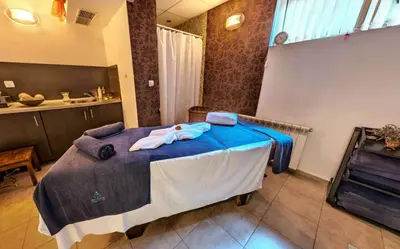 a bedroom with a large bed with blue sheets at Belvedere Holiday Club К505 Sunset View in Bansko