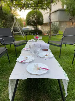 a white table with plates and glasses on it at Family Hotel 