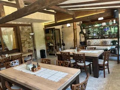 a dining room with wooden tables and chairs at Villa Ema in Panichishte