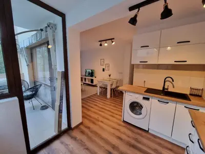 a kitchen and living room with a washing machine at Apartament G&M in Sandanski