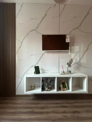a white shelf in a room with a marble wall at Apartament G&M in Sandanski