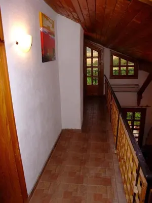 a hallway of a house with a staircase and windows at СПА къща за гости Каза Роза - Swiss Style Chalet Casa Rosa SPA Guest House in Kyustendil