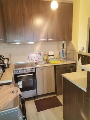 a kitchen with a sink and a stove top oven at Удобство in Petrich
