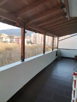 a balcony with a view of the city at Удобство in Petrich