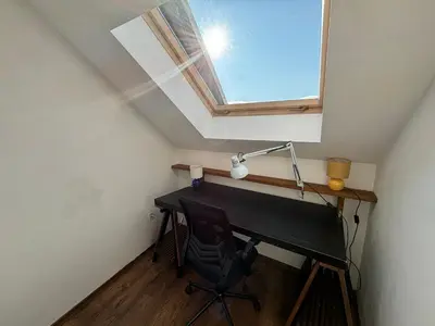 a desk with a lamp and a chair in a attic at Villa Detelina near the Bansko Ski Resort in Razlog