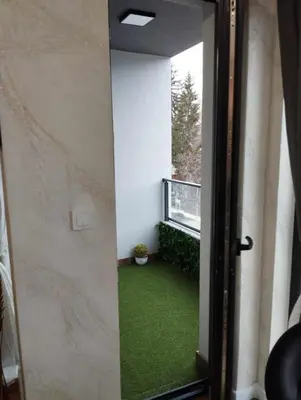 an open door to a balcony with green grass at Апартамент за гости Боляри 2 in Velingrad