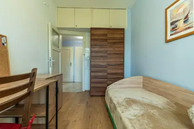 a bedroom with a bed and a desk in it at 3-BR Central Residence in Sofia