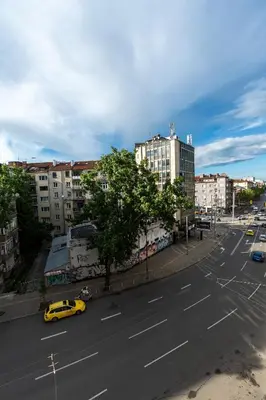 a view of a street with a yellow taxi at 3-BR Central Residence in Sofia