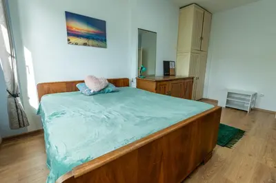 a bedroom with a large wooden bed in a room at 3-BR Central Residence in Sofia