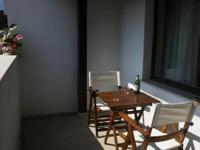 a table with two chairs and a bottle of wine at Bansko Ski Apartments in Bansko Royal Towers in Bansko