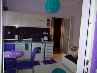 a kitchen with a table and a washing machine at Orange Flower Apartments 1 in Sofia