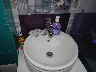 a white sink in a bathroom with soap and detergent at Orange Flower Apartments 1 in Sofia