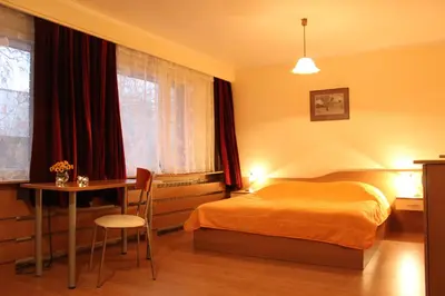 a bedroom with a bed and a desk and a table at Hotel of Bulgarian Academy of Sciences in Sofia