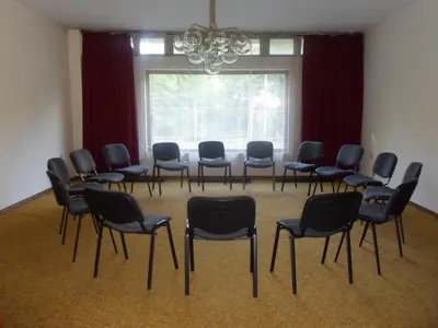 a room with chairs and a table and a window at Hotel of Bulgarian Academy of Sciences in Sofia