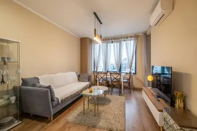 a living room with a couch and a table at The Lemons Cozy Apartment in Sofia