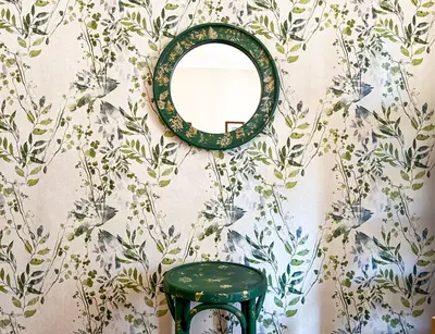a mirror on a wall with a green stool at The Lemons Cozy Apartment in Sofia