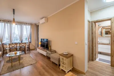 a living room with a couch and a table at The Lemons Cozy Apartment in Sofia