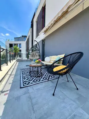 a chair and a table on a patio at Rio Apart Deluxe in Sofia