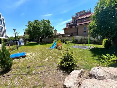 a yard with a playground with a swing at Rio Apart Deluxe in Sofia