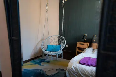 a swinging chair in a room with a bed at 2 Designer Central Apartments FREE Parking Spaces in Sofia