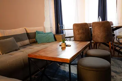 a living room with a couch and a table and chairs at 2 Designer Central Apartments FREE Parking Spaces in Sofia
