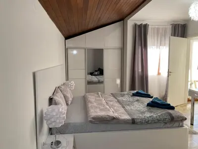 a bedroom with a bed with a large mirror at Къща за гости Casa Per Te село Огняново - село Марчево in Marchevo