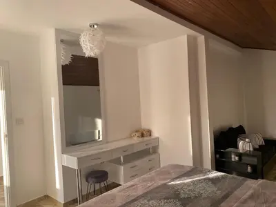 a bedroom with a bed and a tv on a wall at Къща за гости Casa Per Te село Огняново - село Марчево in Marchevo