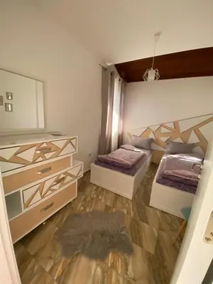 a bedroom with two beds and a mirror at Къща за гости Casa Per Te село Огняново - село Марчево in Marchevo