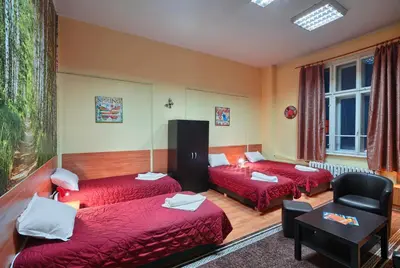 a hotel room with two beds and a chair at Guesthouse32 in Sofia