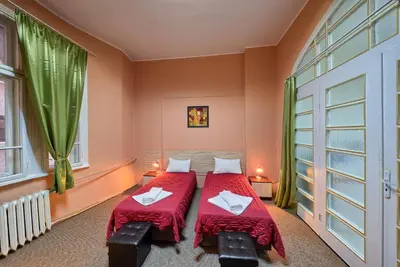 two beds in a room with green curtains at Guesthouse32 in Sofia