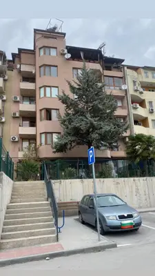a car parked in front of a large building at Апартамент “Djanina 2” in Sandanski