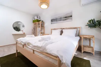a bedroom with a large bed with white sheets at Stylish One-Bedroom Apartment in Plovdiv