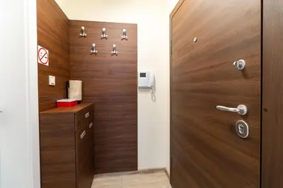 a wooden door in a bathroom with a wooden cabinet at Stylish One-Bedroom Apartment in Plovdiv