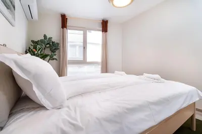 a white bed with white sheets and a window at Stylish One-Bedroom Apartment in Plovdiv