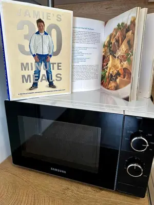 a book sitting on top of a microwave at CENTER Elegant Living in Sofia