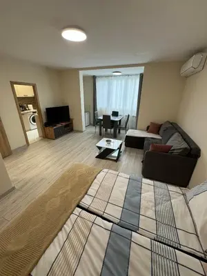 a living room with a couch and a table at Refurbished apartment in a quiet area in Sofia
