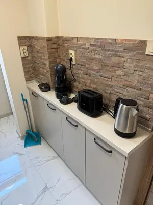 a kitchen with a counter with a microwave on it at Refurbished apartment in a quiet area in Sofia