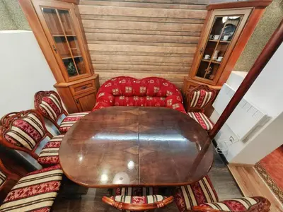 a wooden table and chairs in a room at Central 1-BR Apartment in Sofia