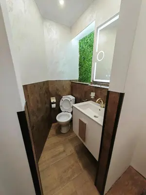 a bathroom with a toilet and a sink and a window at Central 1-BR Apartment in Sofia