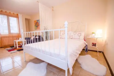 a bedroom with a white bed with a white canopy at 23 Central 1 Bedroom Apartment with Balcony in Sofia