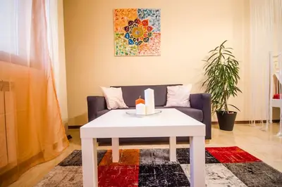 a living room with a white table and a couch at 23 Central 1 Bedroom Apartment with Balcony in Sofia